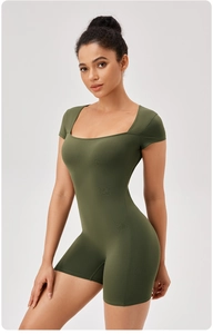 Detail of olive green athletic bodysuit featuring a square neck and short sleeve design