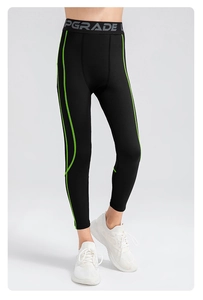 Detail of boys compression leggings with fluorescent green stripes and elastic waistband
