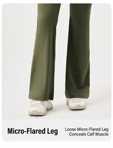 Detail shot of army green flare yoga pants with wide leg hem and white sneakers