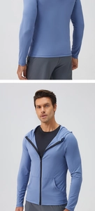Detail of blue men's zip-up sports hoodie with functional fabric and split pockets
