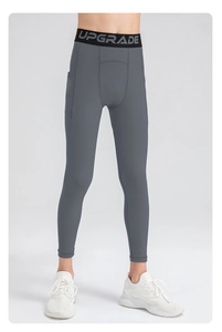 Detail of dark grey kids' compression pants with elastic waistband and side phone pocket