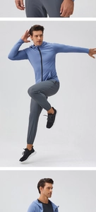 Detailed view of light blue zip-up fitness jacket and grey joggers on a male model