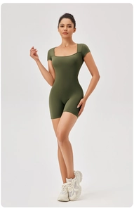 Full view of deep olive green square neck yoga romper with short sleeves and biker shorts