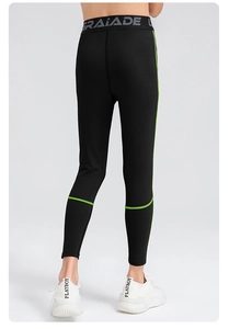 Detail of high-waist boys compression pants with green stitching and logo waistband