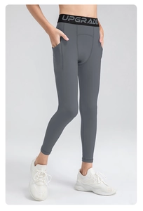 Detail of gray kids sports leggings with wide elastic UPGRADE waistband and side pocket