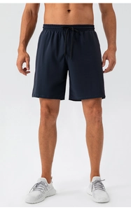 Detail of navy blue sports shorts featuring elastic waistband and black adjustable drawstrings