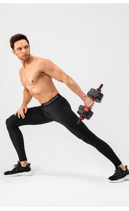 Men's black compression tights with elastic waistband showing high stretch during lunges