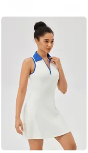 Detail of white tennis dress showing blue polo collar and half-zipper neckline design