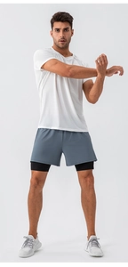 Detail of men's white mesh quick-dry T-shirt and gray 2-in-1 sports shorts for fitness