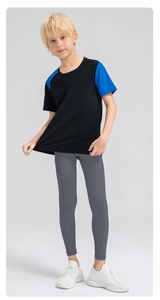 Close-up of boys' quick-dry compression leggings and two-tone athletic shirt detail