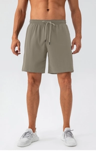 Detail of khaki quick-dry athletic shorts featuring an elastic waist and drawstring