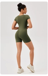 Close-up of dark green yoga bodysuit showing the seamless fit and premium fabric texture
