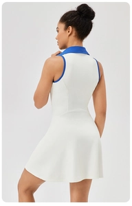 Detail of white tennis dress showing blue contrast piping on collar and sleeveless armholes