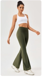 Full view of white racerback sports top and dark green high waist flared yoga pants