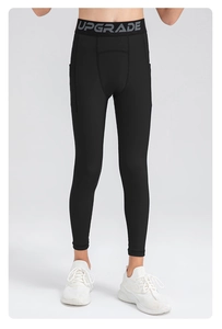 Detail of boys' black athletic compression leggings with side pockets and elastic waist