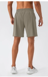 Detail view of quick-dry nylon sports shorts showing breathable fabric and draped back fit