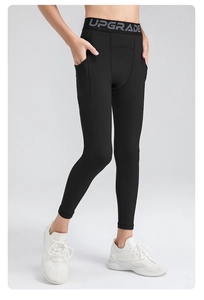 Detail of boys' compression pants showing side pocket and elastic waist with text