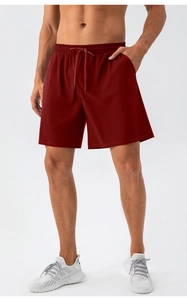 Close-up of breathable mesh fabric on men's quick-dry sports shorts in burgundy color