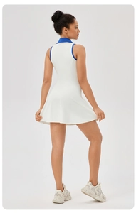 Detail of white tennis dress with blue polo collar and sleeveless A-line silhouette
