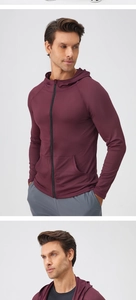 Close-up of men's burgundy long sleeve sports jacket with full zipper and raglan sleeves
