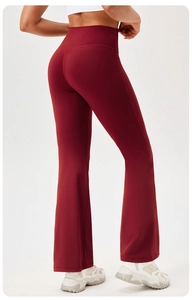 Rear view of high-waisted dark red yoga flare pants showing slimming lift fit