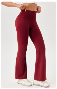 Detail view of high waist flared yoga pants in dark red with elastic sculpting fabric