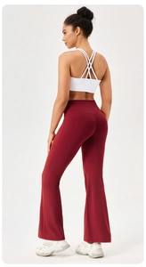 Rear view of high waisted burgundy flared yoga pants and white cross back sports bra