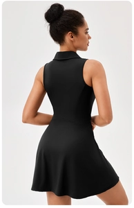 Back view of a sleek black athletic tennis dress with lapel collar and slim fit tailoring