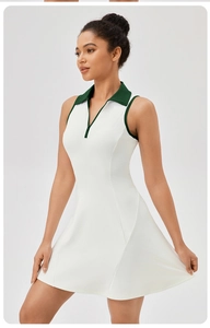 Detail of white tennis dress with dark green polo collar and zipper closure
