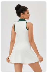 Back view of white tennis dress with contrast green lapel and waist slimming fit