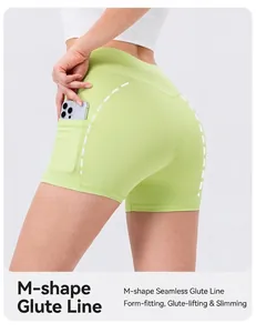Detail of high waisted green yoga shorts with M-shaped lifting seam and side phone pocket