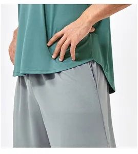 Detail of dark green mesh tank top featuring a curved hem and breathable fabric structure