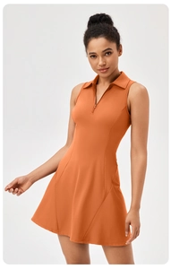 Detail view of orange tennis dress showing polo collar, zipper and high-stretch fabric