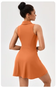 Detail of orange sleeveless tennis dress featuring a lapel collar and athletic fit
