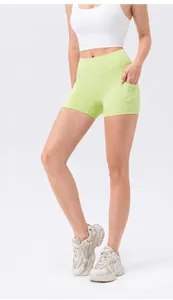 Detail view of high waisted yoga shorts in mint green with functional side pockets