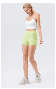 Detail of high waisted yoga shorts featuring functional side pockets and seamless fit