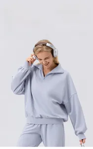 Detail of half-zip collar and ribbed cuffs on light blue casual women's sports sweatshirt