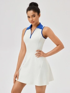 White sleeveless tennis dress with blue trim, zip-up polo collar and A-line silhouette