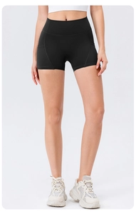 Detail of high-waisted black yoga shorts showing the seamless contour and lifting effect