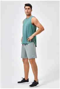 Men's dark green fitness tank top and grey sports shorts with reflective details