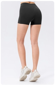 Detail view of high waist yoga shorts with side pockets and butt lifting seams