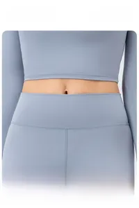 Detail showing the widened high waist design for tummy control on blue yoga pants