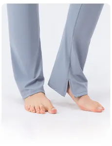 Detail of inner side slit on high-waist flared yoga pants with blue elastic fabric
