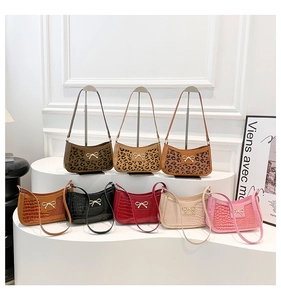 Collection of croc-pattern and leopard print baguette bags with golden bow buckles