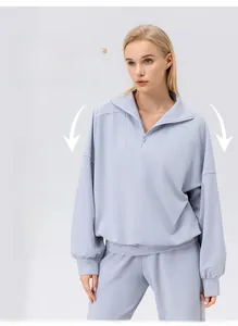 Detail of light purple sportswear set featuring a half-zip sweatshirt and loose fit design