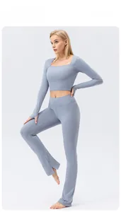 Detail of high-waist flared yoga pants and thumb-hole long sleeve crop top in blue-gray