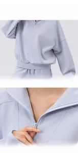 Detail of half-zip sweatshirt featuring smooth zipper and elastic ribbed cuffs and hem