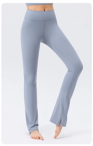 Close-up of high-waist flared yoga pants featuring stylish side slits at the ankle hem