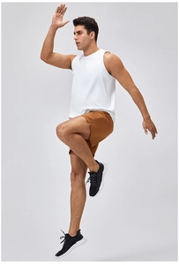 Men's breathable white sports tank top and brown shorts set shown in dynamic jump