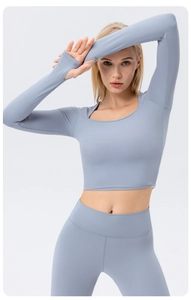 Close-up of long sleeve yoga top featuring functional thumb holes and matte elastic fabric